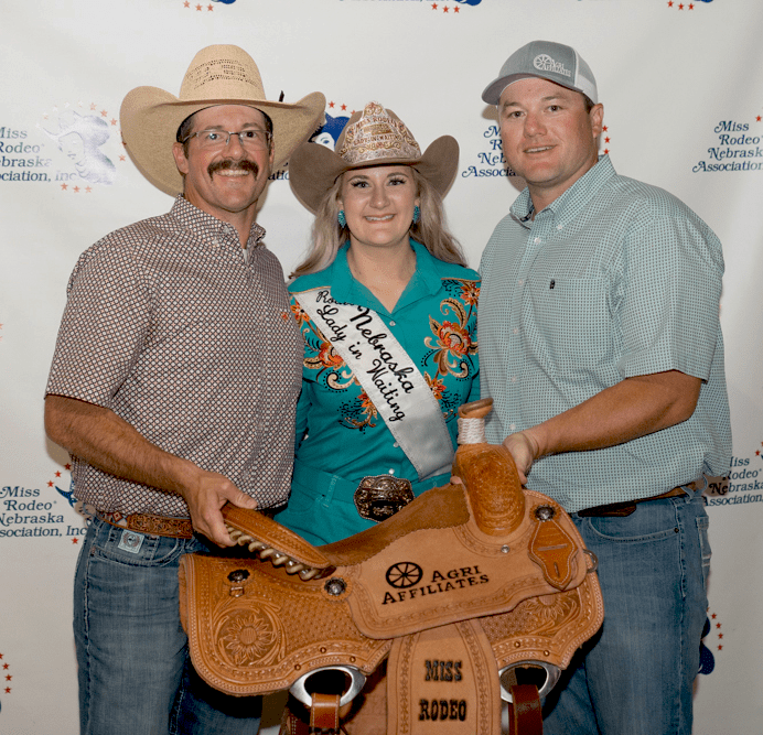 chase dodson, miss rodeo nebraska danielle forster, and D.J. Lunkwitz real estate professionals with Agri Affiliates present the 2024 custom sponsored saddle.