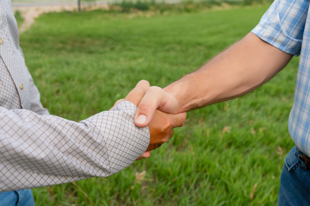 land management Agri Affiliates agri affiliates farm and ranch manager handshake with absentee land owner